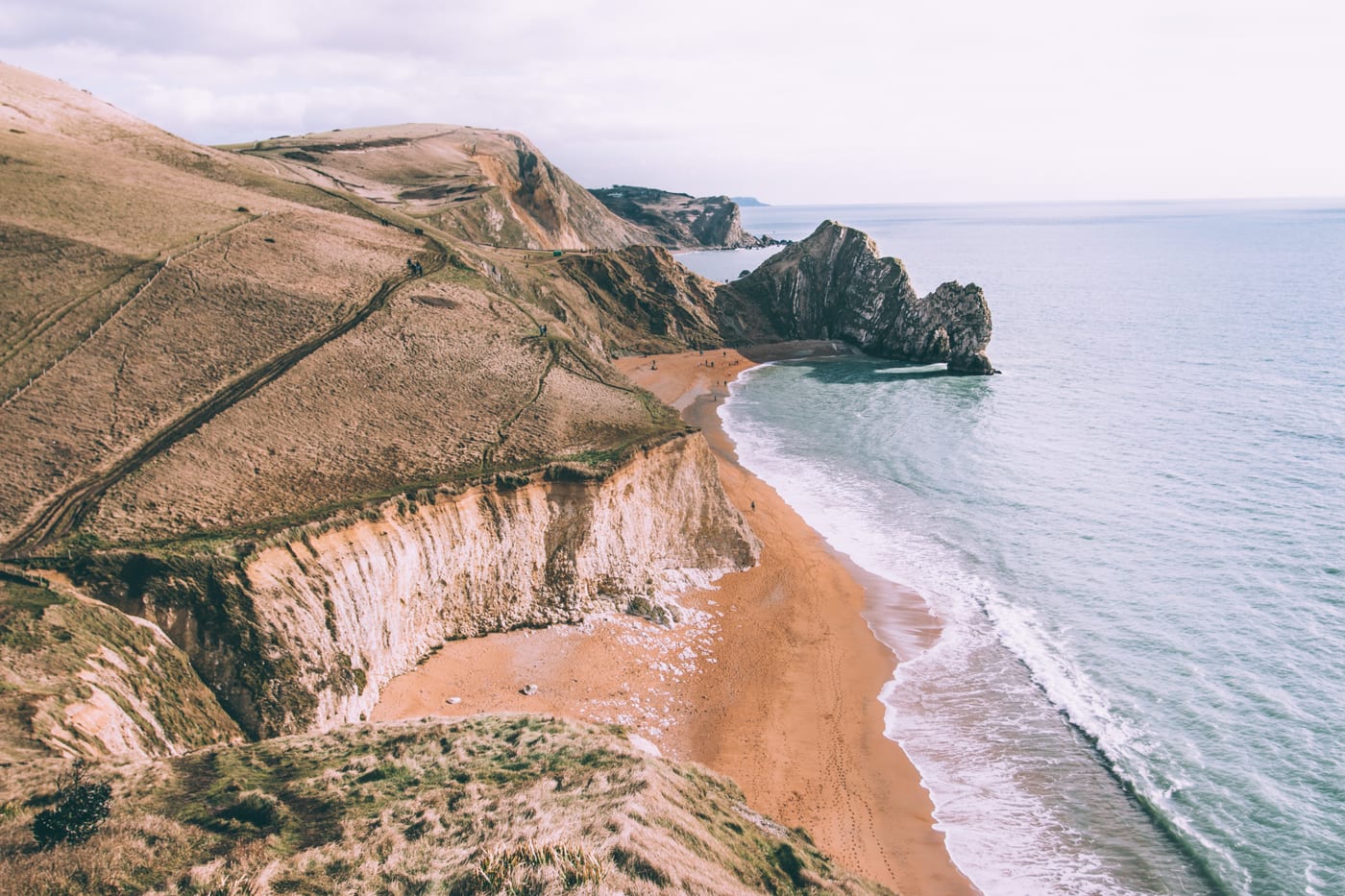 Chalk cliffs and a long beach seen from the air